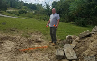 Brother Brian Seeger, contractor, marks the outline for the new house’s foundation.