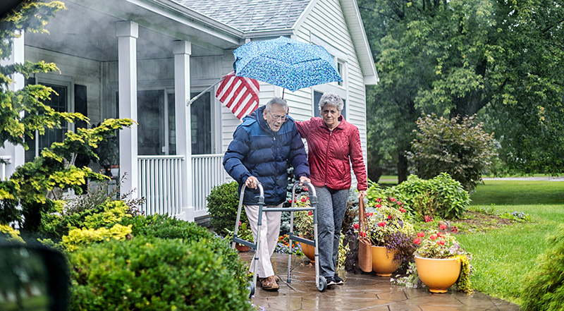 GettyImages-1071595354-horizontal Elderly woman and man walking together in the rain