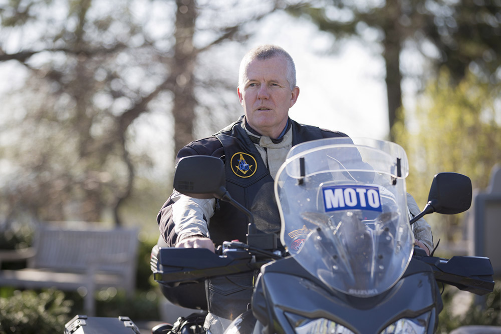 Freemason riding motorcycle outdoors