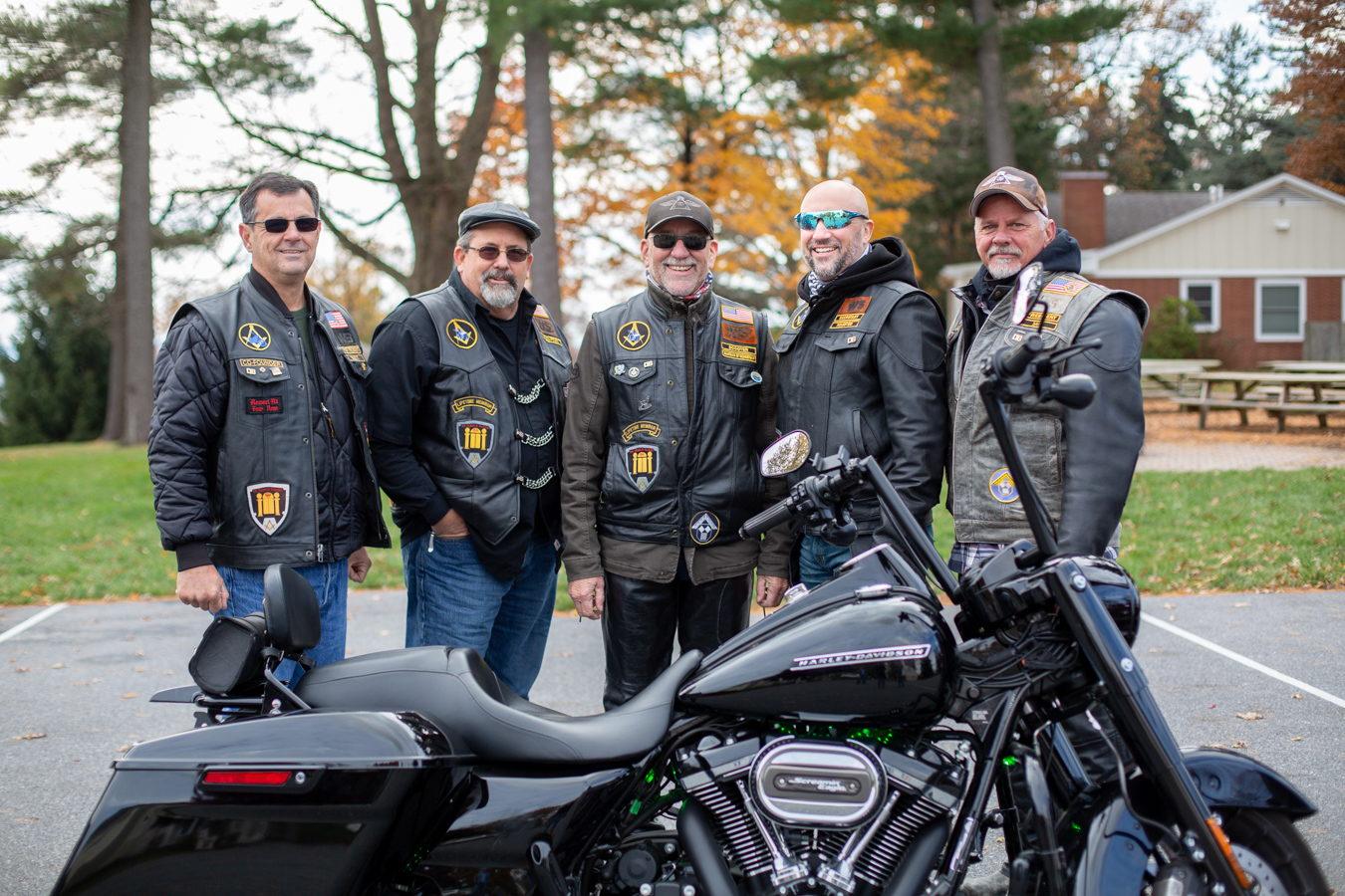 Motorcyclists standing behind a bike