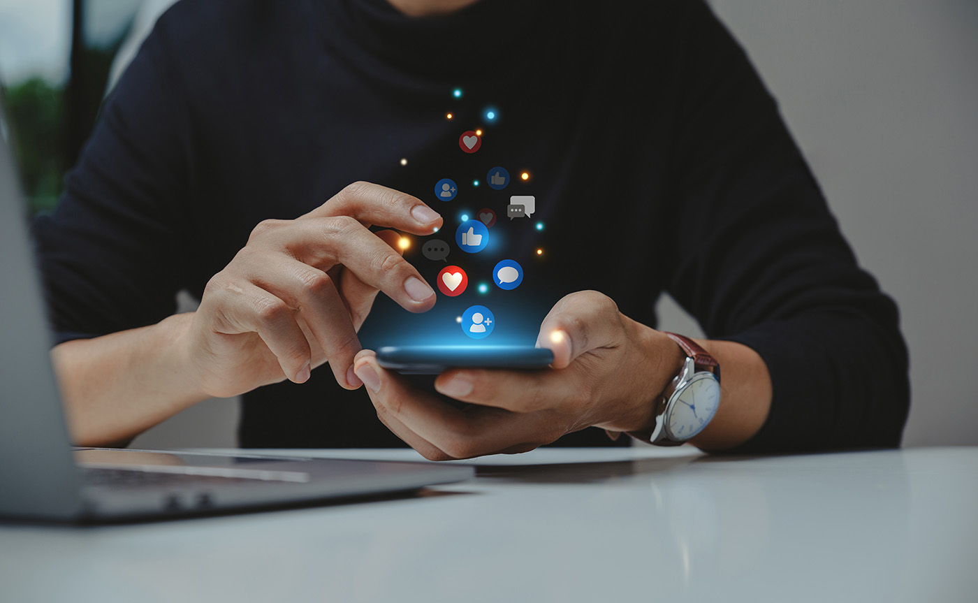 GettyImages-15242103262 person browsing social media on their phone