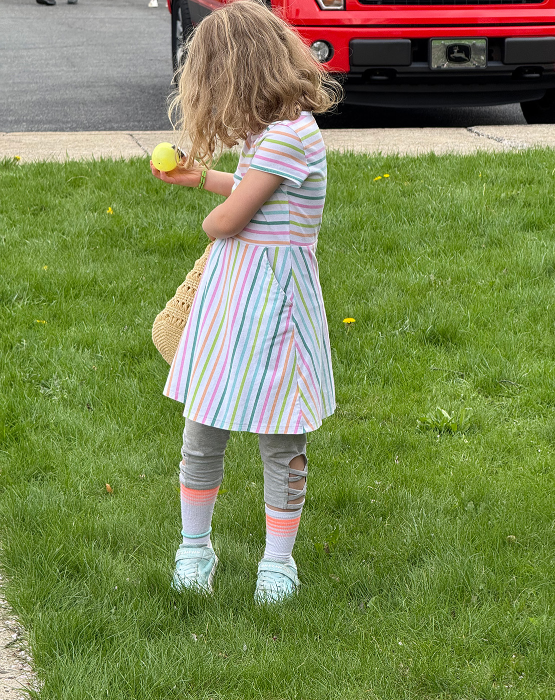 IMG_3893 little girl adding Easter egg to bag