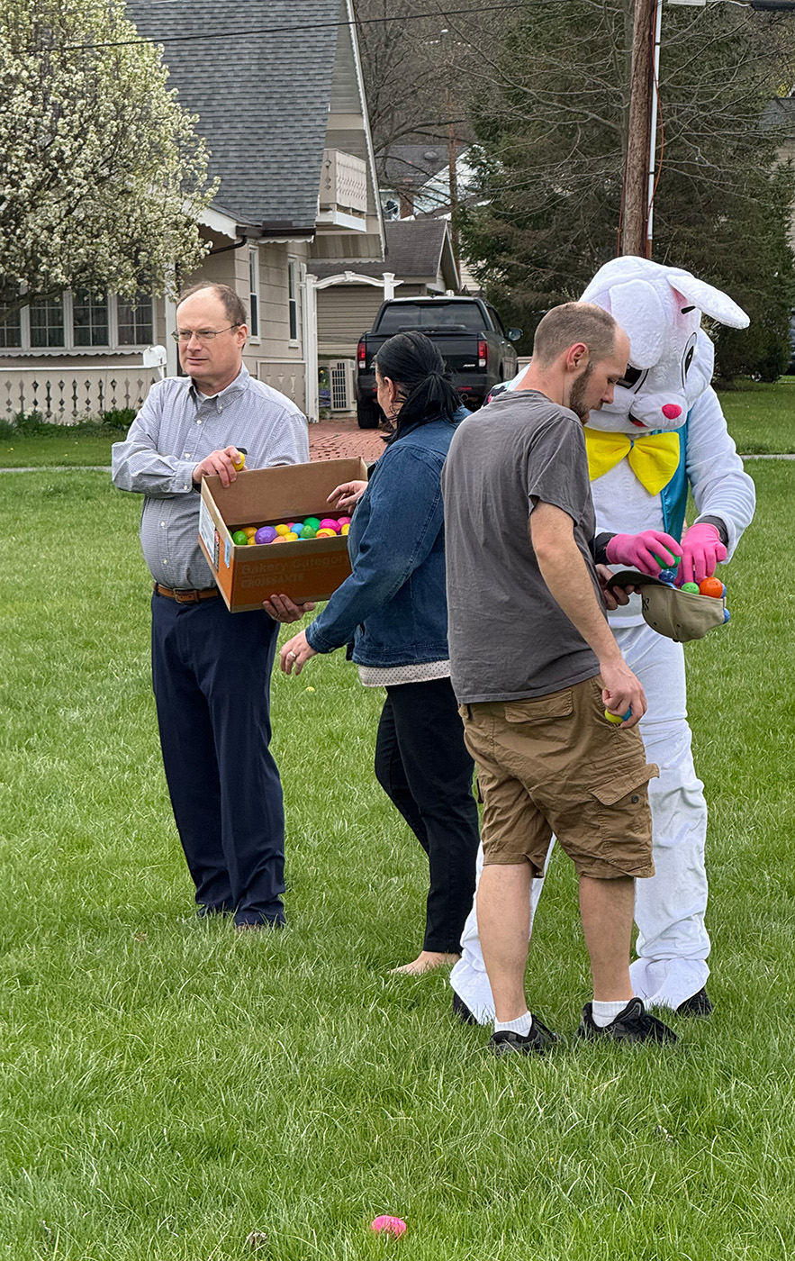IMG_3937 Adults hiding eggs outdoors with Easter Bunny