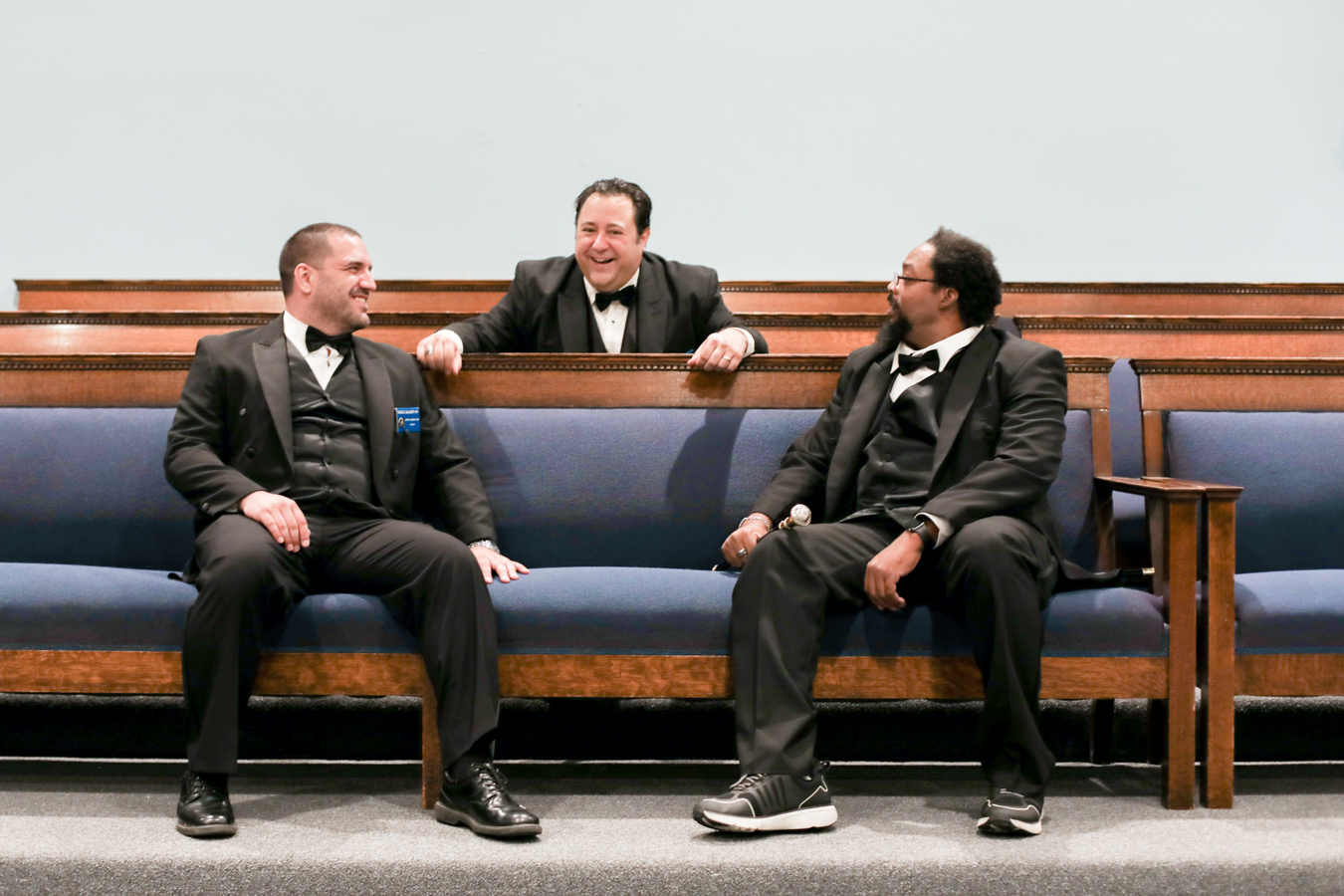 Three men in Masonic dress sitting in lodge together